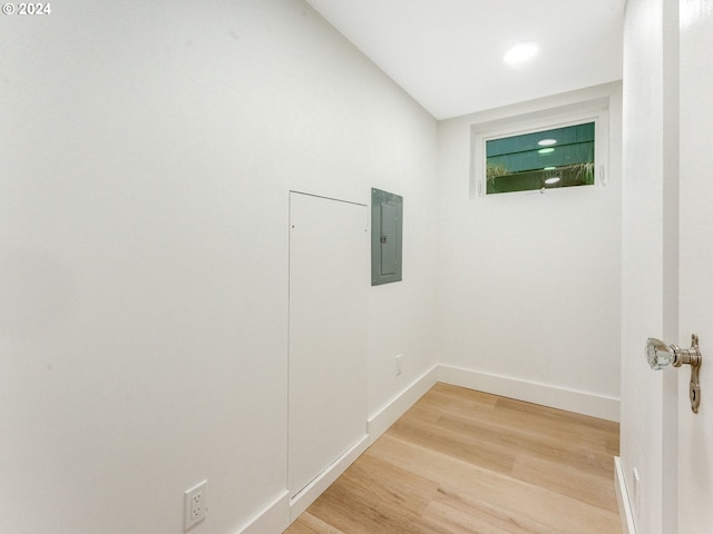 interior space featuring electric panel and light hardwood / wood-style floors