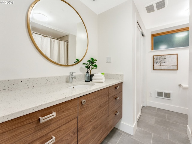 bathroom with tile patterned flooring and vanity