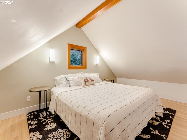 bedroom featuring vaulted ceiling with beams and wood-type flooring