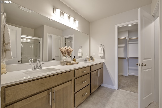 bathroom featuring vanity and a shower with door