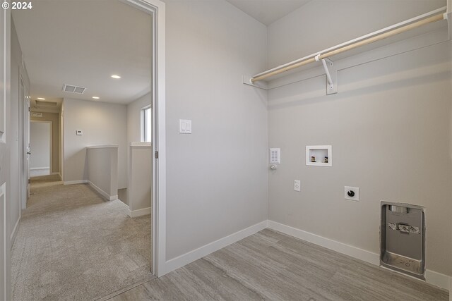 laundry area featuring hookup for an electric dryer, hookup for a washing machine, and light wood-type flooring