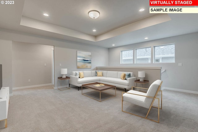 living room featuring a raised ceiling and light carpet