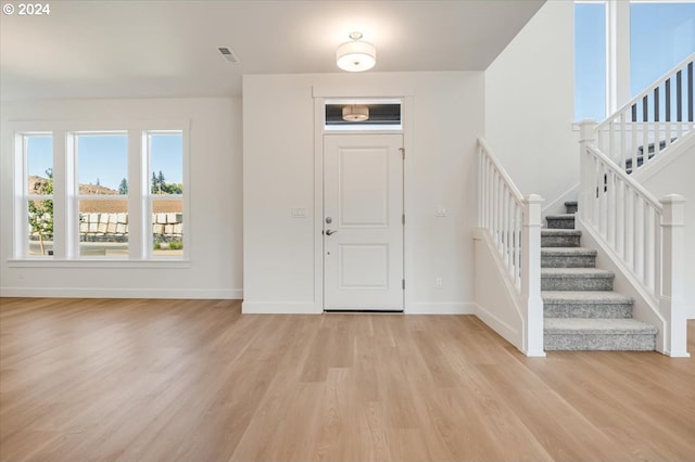 foyer entrance with light hardwood / wood-style flooring