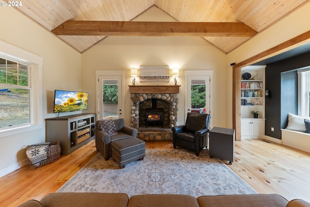 living room with light wood-type flooring, a wealth of natural light, and vaulted ceiling with beams