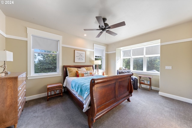 carpeted bedroom with multiple windows and ceiling fan