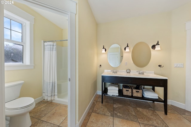 bathroom with vanity, toilet, a shower with curtain, and vaulted ceiling