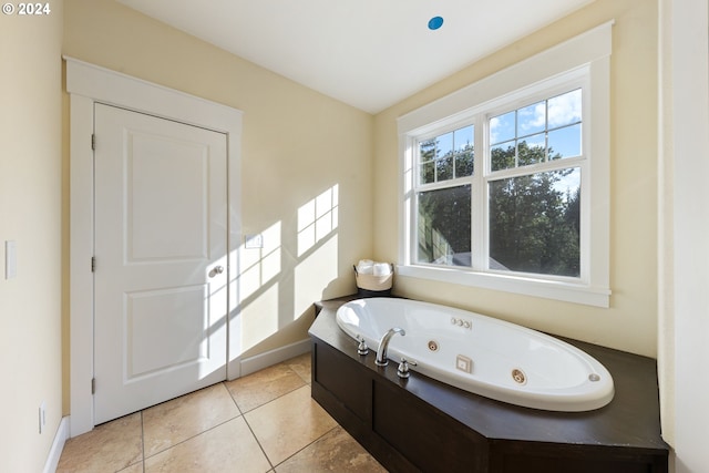 bathroom with tile patterned floors and a washtub