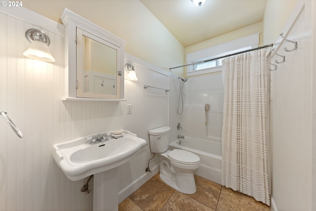 bathroom with shower / bath combo with shower curtain and toilet