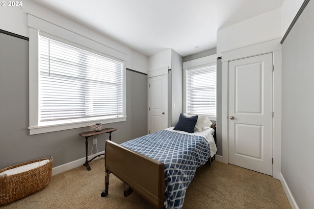 carpeted bedroom featuring multiple windows