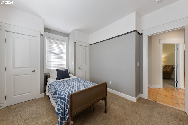 bedroom with light wood-type flooring and a closet