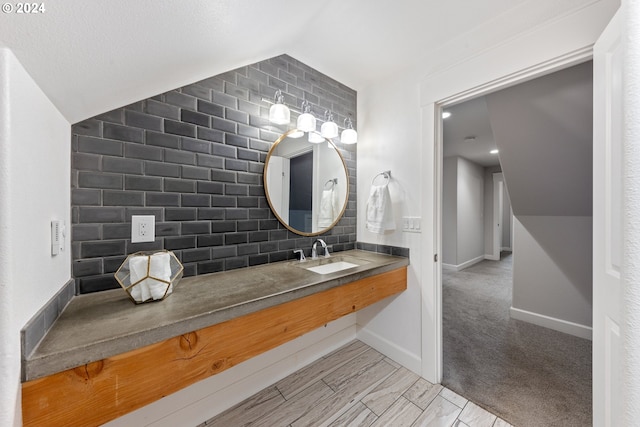 bathroom with lofted ceiling, backsplash, and vanity