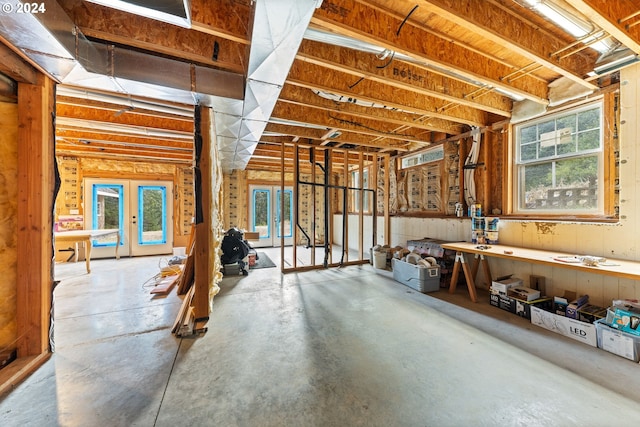 basement featuring french doors and plenty of natural light