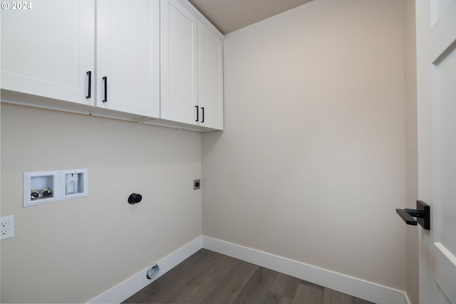 washroom with electric dryer hookup, cabinets, dark wood-type flooring, and washer hookup