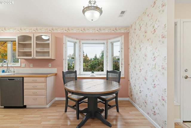 dining room with light hardwood / wood-style floors and sink