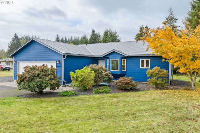 ranch-style house with a garage and a front yard