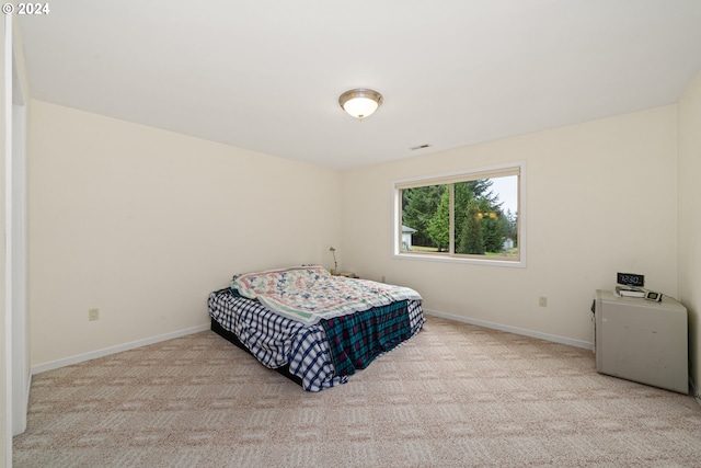 bedroom featuring light carpet