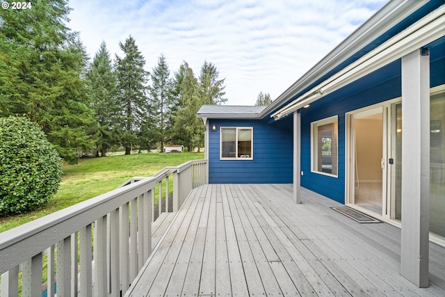 wooden terrace featuring a yard