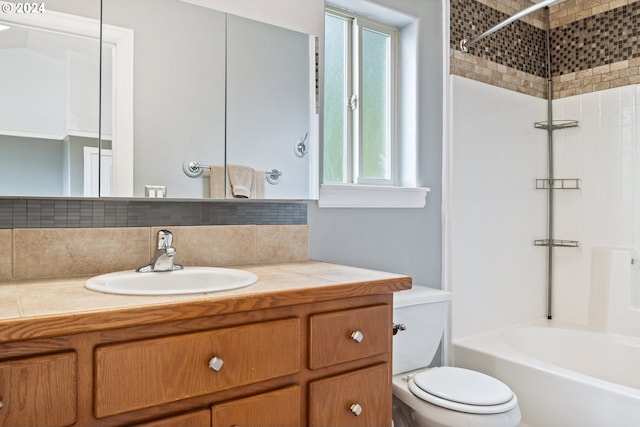 full bathroom with toilet, decorative backsplash, tiled shower / bath combo, and vanity