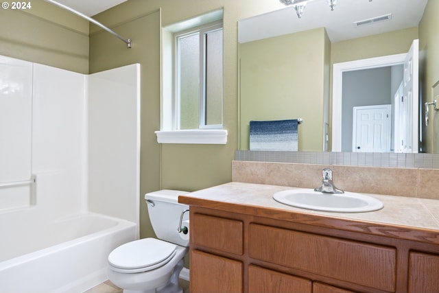 full bathroom with vanity, toilet, tasteful backsplash, and shower / washtub combination