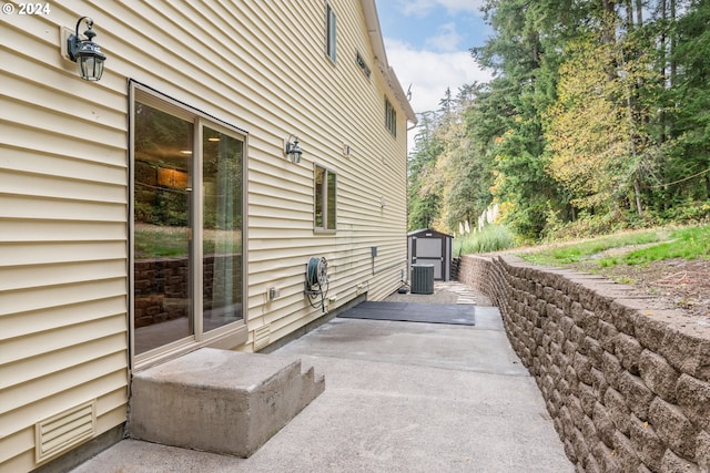 view of property exterior featuring central AC and a patio