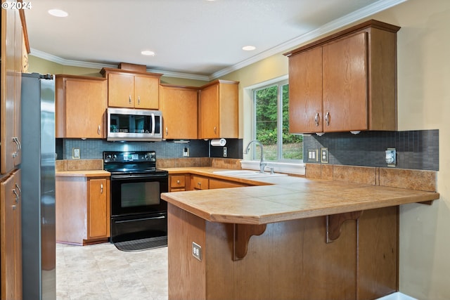 kitchen featuring kitchen peninsula, backsplash, ornamental molding, sink, and appliances with stainless steel finishes