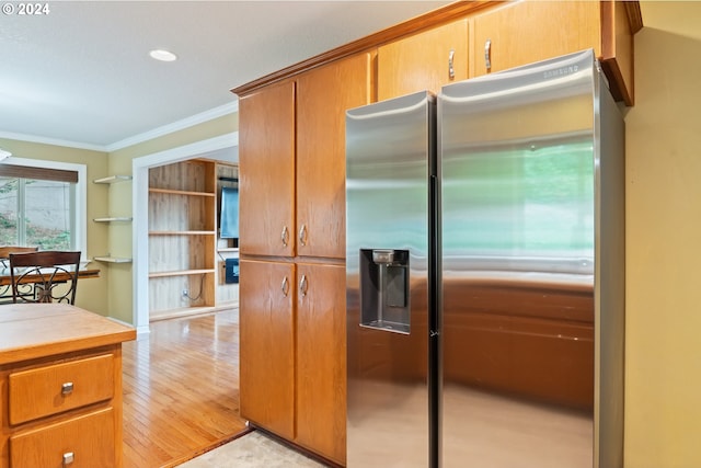 kitchen featuring ornamental molding, light hardwood / wood-style flooring, and stainless steel refrigerator with ice dispenser