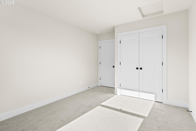 unfurnished bedroom with a closet and light carpet