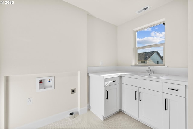 laundry room featuring cabinets, electric dryer hookup, sink, hookup for a washing machine, and light tile patterned flooring