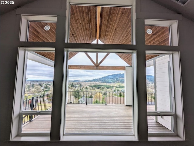 doorway to outside with lofted ceiling and a mountain view