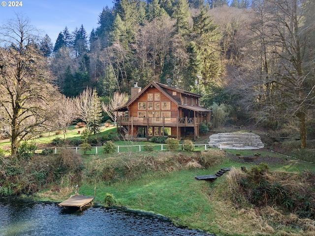 back of house featuring a water view