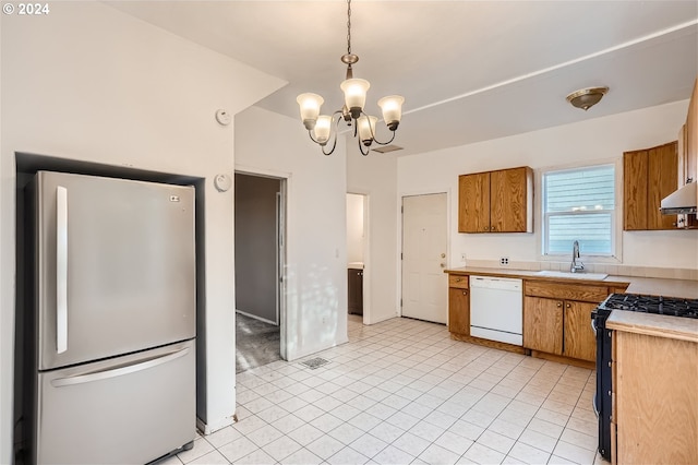 kitchen featuring light tile flooring, hanging light fixtures, white appliances, sink, and a chandelier