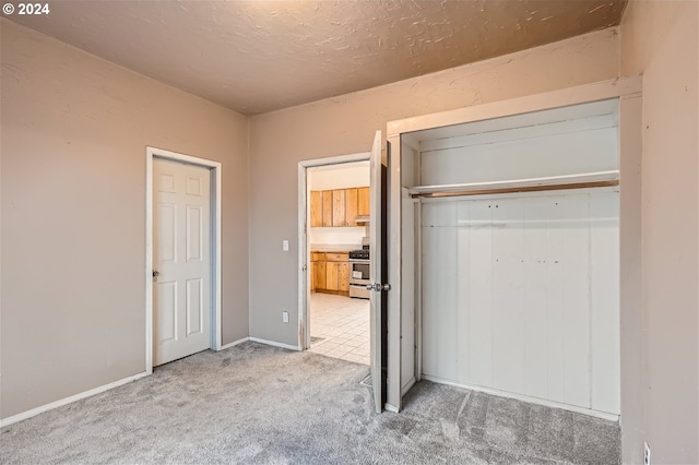 unfurnished bedroom featuring a closet and light carpet