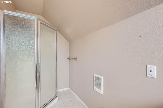 bathroom with tile flooring and lofted ceiling