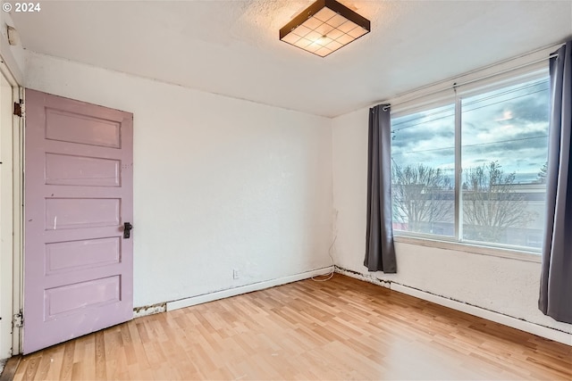 spare room with light wood-type flooring