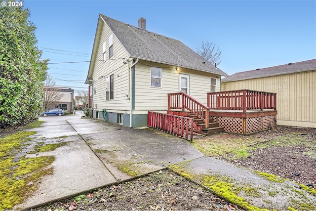 back of house with a wooden deck