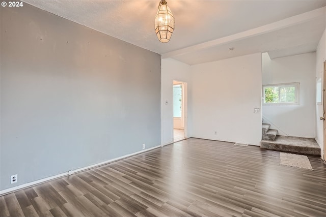 unfurnished room with dark hardwood / wood-style flooring