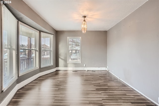 empty room with dark wood-type flooring