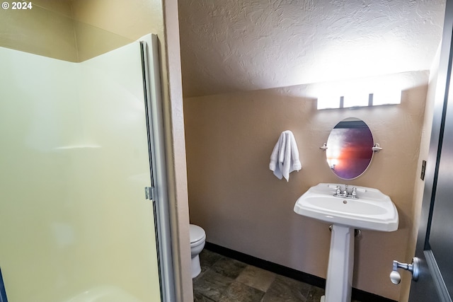 3348 Talon St, Eugene, OR 97408 - bathroom with toilet, a textured ceiling, a shower stall, and baseboards