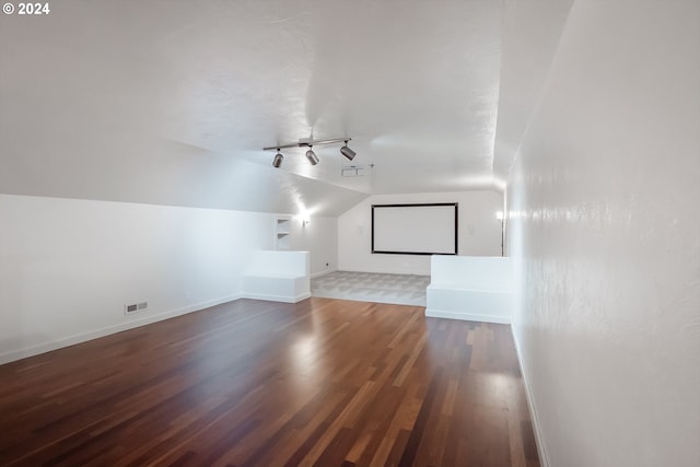 bonus room featuring vaulted ceiling and dark hardwood / wood-style floors