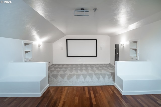 3348 Talon St, Eugene, OR 97408 - carpeted home theater room featuring wood finished floors, built in shelves, and lofted ceiling