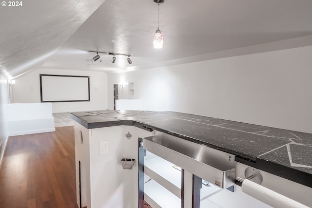 home theater with wine cooler, dark wood-type flooring, and vaulted ceiling