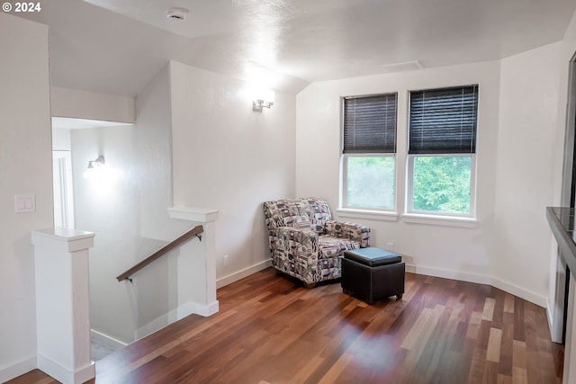 sitting room with vaulted ceiling and hardwood / wood-style flooring