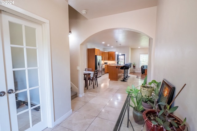 hall with light tile patterned floors