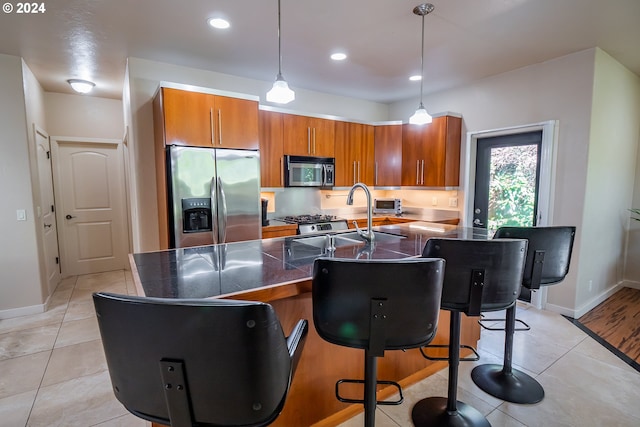 3348 Talon St, Eugene, OR 97408 - kitchen with a sink, appliances with stainless steel finishes, tile counters, and brown cabinets