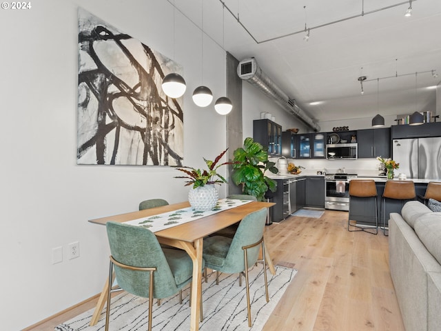 420 NW 11th Ave Unit 502, Portland, OR 97209 - dining space with light wood-style flooring and track lighting