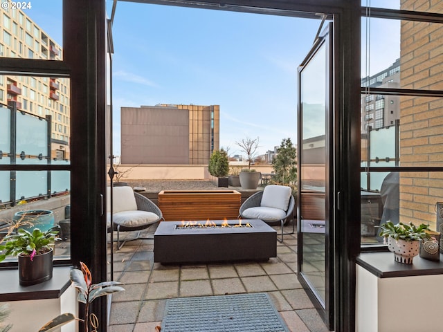 balcony featuring a fire pit and a patio area