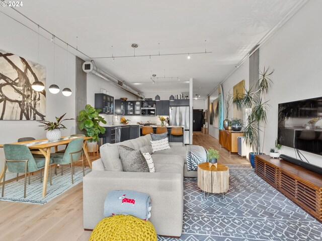 living room with hardwood / wood-style floors and sink