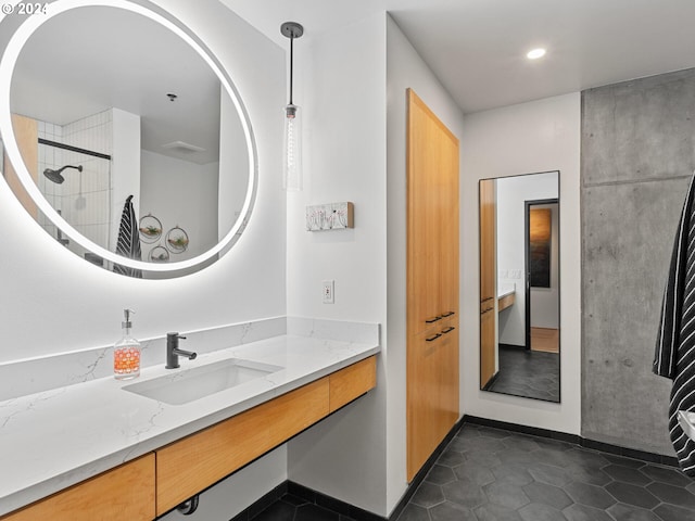 bathroom featuring tile patterned floors, a shower, and vanity