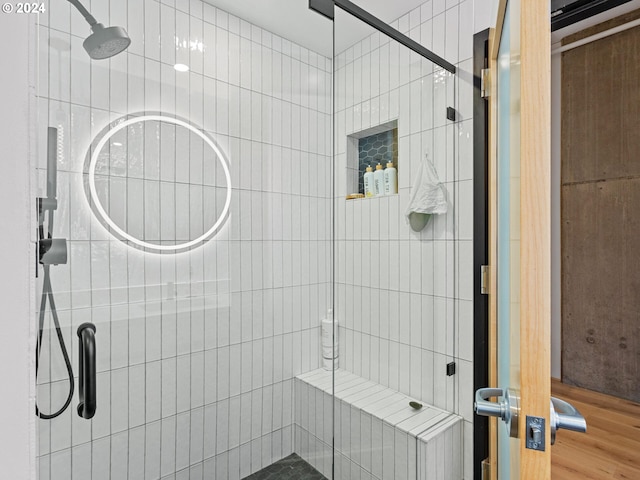 bathroom featuring a shower with shower door