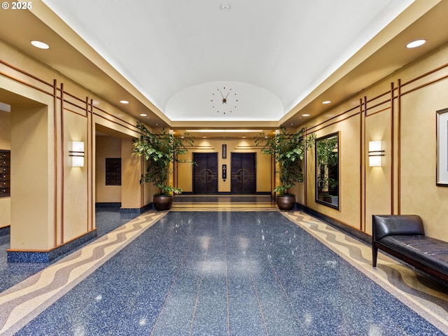 building lobby featuring recessed lighting and lofted ceiling